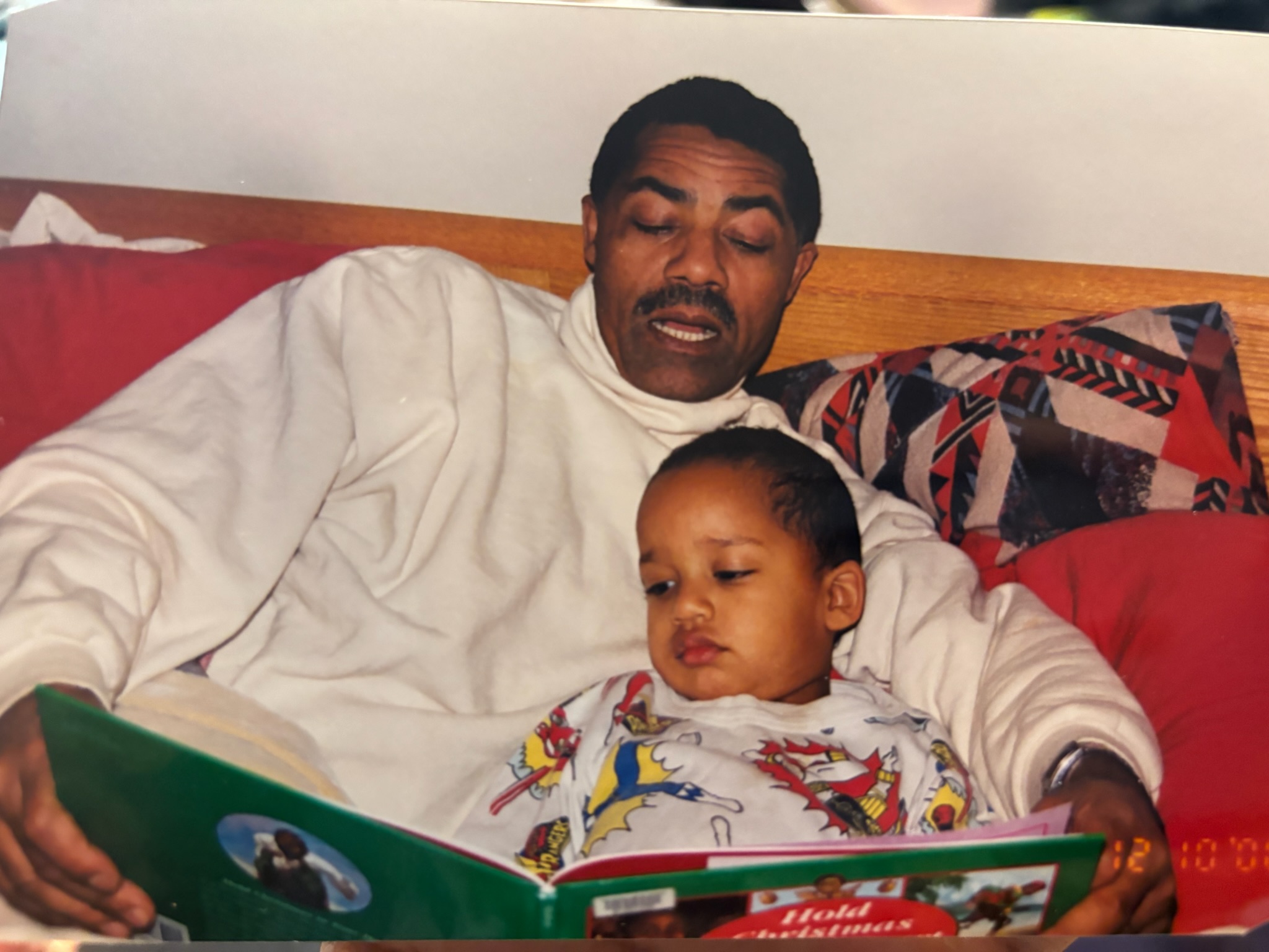 Sasu being read to by his father